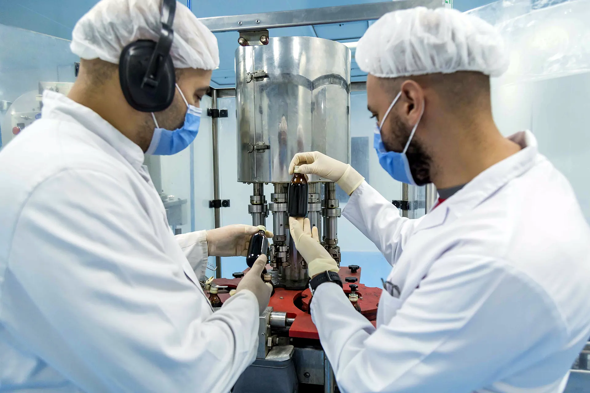 Engineers inspecting a production machine